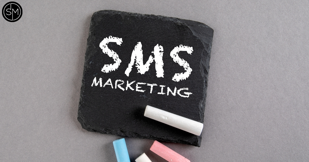 SMS marketing text on a black board