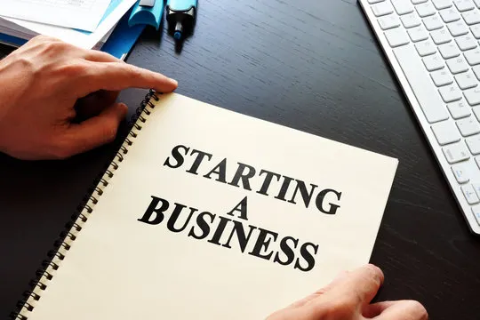 Notebook that says starting a business